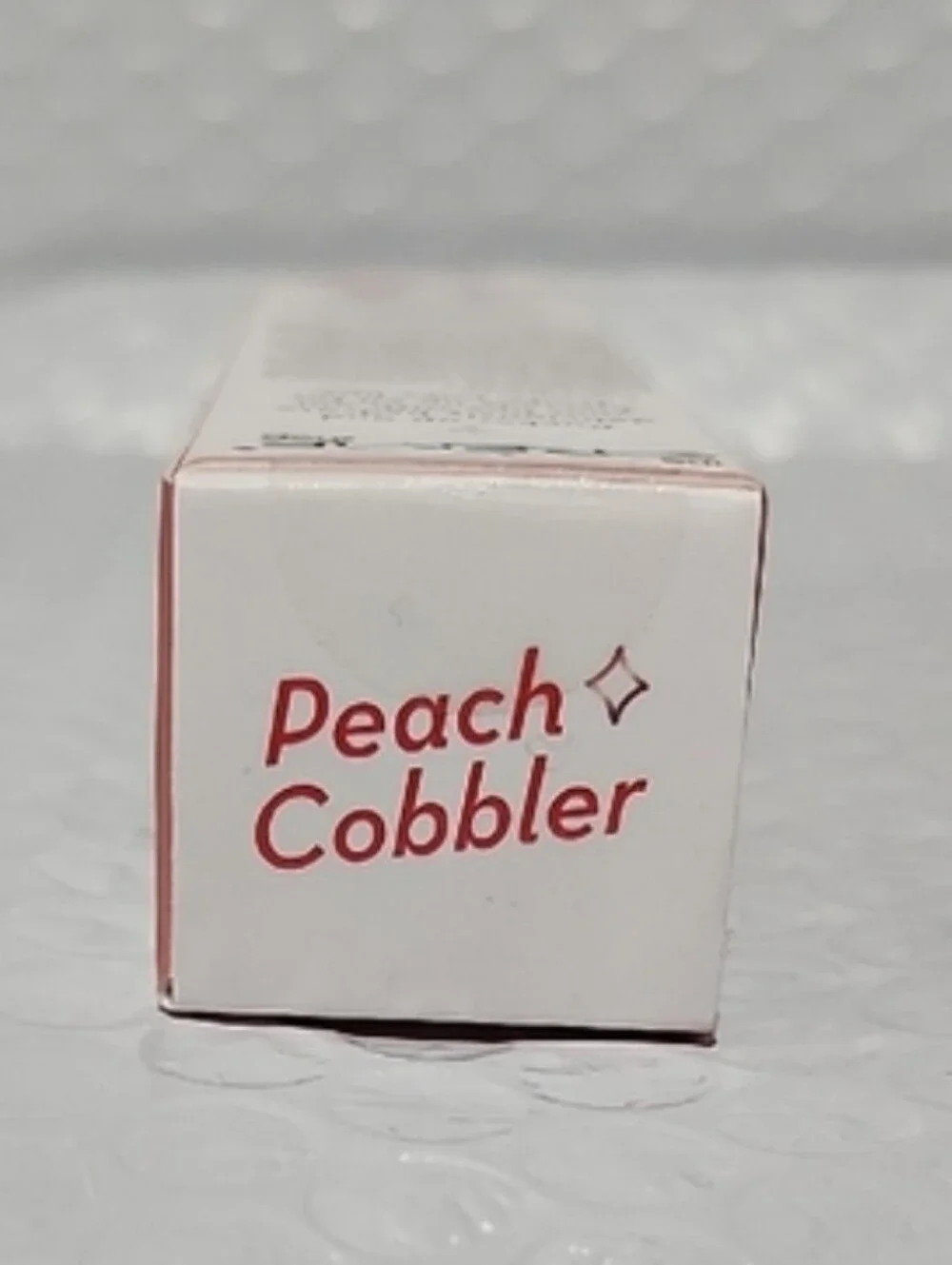 The Creme Shop Lucious Lip Oil in Peach Cobbler